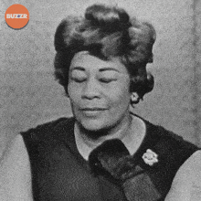 a black and white photo of a woman with a buzzr logo in the upper right corner