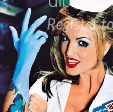 a woman in a nurse costume is wearing a blue glove