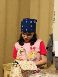 a girl wearing a bandana and a princess shirt