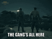 a group of soldiers standing in front of a lighthouse with the words the gang 's all here above them