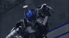 a close up of a robot with a blue helmet and red and black armor