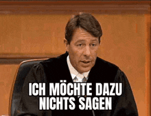 a judge is sitting in a courtroom with the words ich mochte dazu nichts sagen written on the screen .