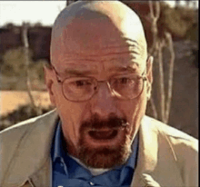 a close up of a man with glasses and a beard making a funny face .