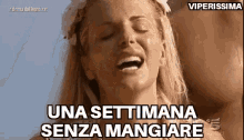 a woman is laughing with her eyes closed and the words una settimana senza mangiare on the bottom .