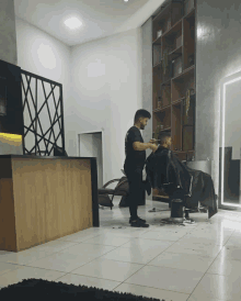 a man cutting another man 's hair in a salon