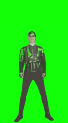 a man in a green and black outfit is standing in front of a green screen