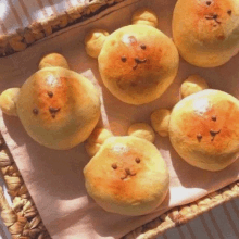 a bunch of bear shaped breads in a basket on a table