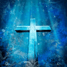 a wooden cross on a blue background with a light shining through it