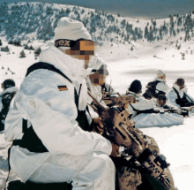 a man wearing a vex hat sits in the snow with other soldiers