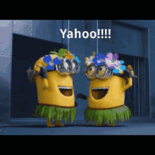 two minions wearing hula skirts and hats are standing next to each other with yahoo written on the screen