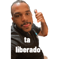 a man giving a thumbs up with the words ta liberado written on his shirt