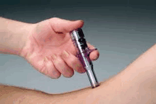 a person is holding a purple syringe over another person 's arm and injecting it into another person 's arm .