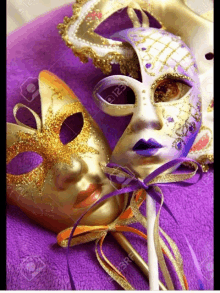 a gold and purple carnival mask on a purple background