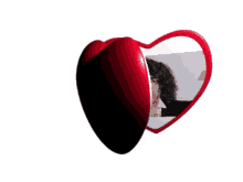 a picture of a woman in a heart shaped mirror