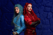 a woman with blue hair and a woman with red hair stand back to back with their arms crossed