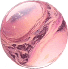 a close up of a pink and purple marbled ball on a white surface .