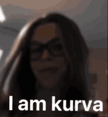 a blurred image of a woman with glasses and the words i am kurva