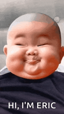 a baby is smiling and making a funny face .