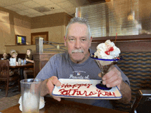 a man holding a plate that says happy fathers day on it