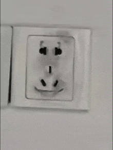 a black and white photo of a socket with a face on it .