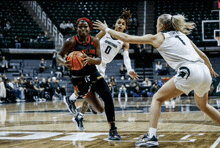 a female basketball player with the number 0 on her shirt