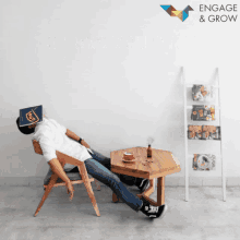 a man laying on a chair with a book covering his face and the words engage & grow behind him