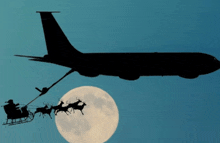 a sleigh pulled by reindeer is being pulled by a plane