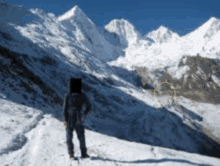 a person standing on top of a snowy mountain with a yellow circle in the middle