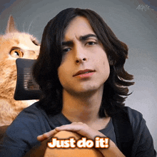 a man with long hair says just do it with a cat in the background