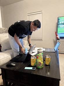 a man standing next to a table with a can of scout soda