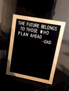 a blackboard with a quote from dad that says " the future belongs to those who plan ahead "