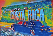 a black car is parked in front of a sign that says costa rica