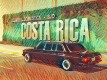 a black car is parked in front of a sign that says costa rica