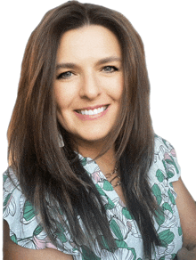 a woman wearing a floral shirt is smiling for the camera