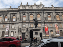 a statue of a man riding a horse in front of a building with a banner that says hbo on it