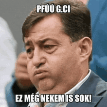 a man in a suit has a meme on his face that says ez meg nekem is sok !