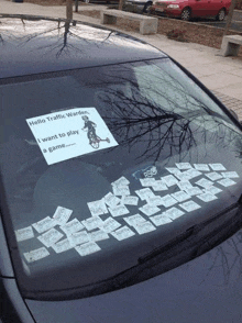 a car has a sign on the windshield that says hello traffic warden