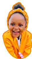 a little girl wearing a yellow jacket and a headband with pearls