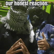 a man wearing a scarf on his head giving a thumbs up next to another man