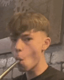 a young man is smoking a hookah in a room .