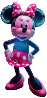 a statue of minnie mouse wearing a blue shirt and a pink polka dot skirt