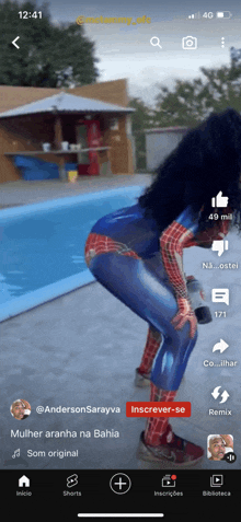 a woman in a spiderman costume is on a cell phone screen