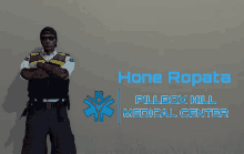 a man in a police uniform is standing in front of a sign that says hone ropata pillbox hill medical center