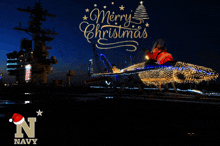 a picture of a fighter jet decorated for christmas with the words merry christmas on it