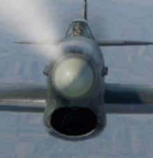 a fighter jet is flying through the air with smoke coming out of its nose