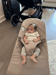 a baby in a bouncer with a warning label