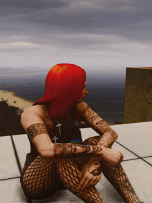 a woman with red hair is sitting on a ledge with a view of the ocean