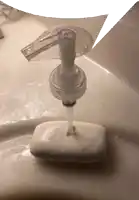 a soap dispenser is sitting on top of a soap bar