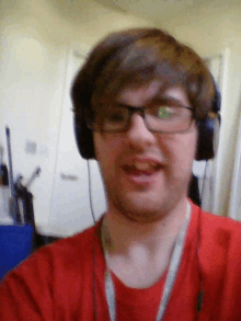 a man wearing headphones and a red shirt