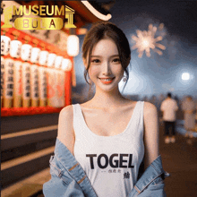 a woman wearing a white tank top with the word togel on it